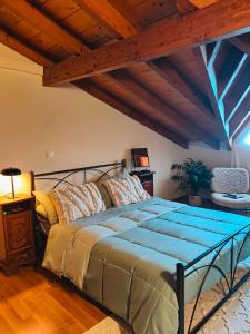 a bedroom with a large bed with a wooden ceiling at Barbati Sunrise Suite in Barbati