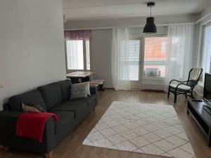 a living room with a couch and a tv at Apartment Korsholma2 in Vaasa