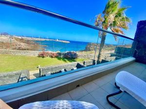 a room with a large window with a view of the ocean at Oceanview Villa Gaviota in San Miguel de Abona