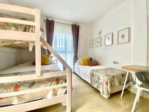 a bedroom with two bunk beds and a desk at Oceanview Villa Gaviota in San Miguel de Abona