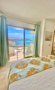 a bedroom with a bed and a view of the ocean at Oceanview Villa Gaviota in San Miguel de Abona
