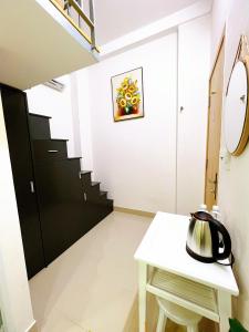a room with a white table and a staircase at Lucky Hotel Apartment in Ho Chi Minh City