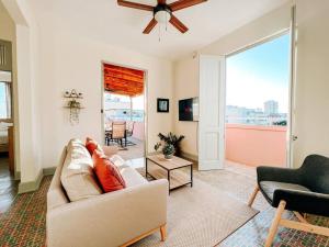 uma sala de estar com um sofá e uma ventoinha de tecto em Picaflor 9 Miramar Comfy Apt PH W/ Amazing View em San Juan