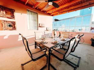 a dining room table with chairs in a room at Picaflor 9 Miramar Comfy Apt PH W/ Amazing View in San Juan