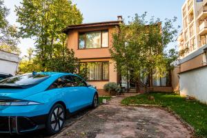 a blue car parked in front of a house at Sweet Home in Sofia