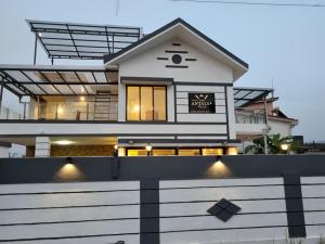 a house with a white fence in front of it at Antalya Villa in Malavli