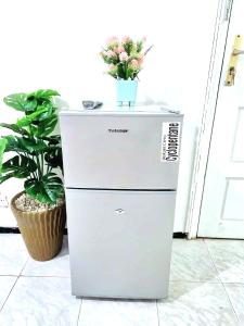 a refrigerator with a vase of flowers on top of it at Mi mini estudio 2 in Rabat