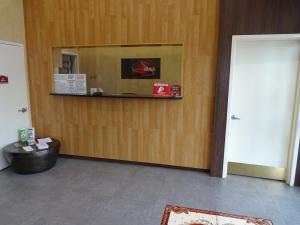 a waiting room with a counter and a mirror at Hotel Bliss - Brooklyn in Brooklyn