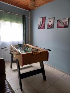 a foosball table in the corner of a room at Kaz à Naja in Saint-Louis