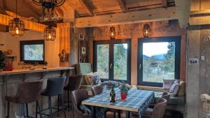 a living room with a table and a bar at Berghaus Weissbriach in Weissbriach