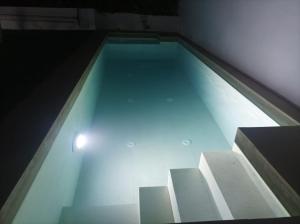 a swimming pool with some stairs in a room at CASA RURAL ALCALDE RIVERA in La Carrasca