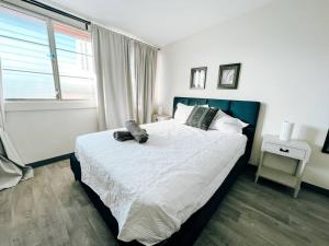 a bedroom with a large bed and a window at Picaflor 10 Spacious Elegant PH Apt @ Miramar in San Juan