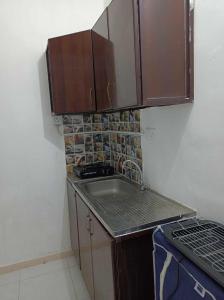 a small kitchen with a sink and a stove at nice room inside an apartment in Abu Dhabi