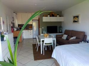 a living room with a bed and a table and chairs at Paraje El Pozo in Málaga