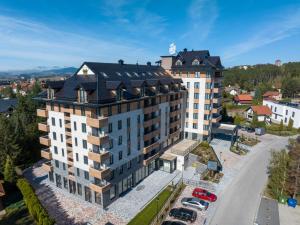 an aerial view of a large building with a black roof at BuzzStays - Spa & Wellness Hotel - Privately Managed Apartments in Zlatibor