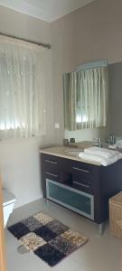 a bathroom with a sink and a mirror at Vale Poços House in Vinha da Rainha