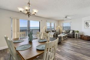 a dining room and living room with a table and chairs at Emerald Isle 603 in St Pete Beach