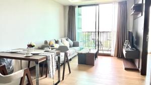 a living room with a couch and a table at The Astra 2bedroom apartment in Chiang Mai