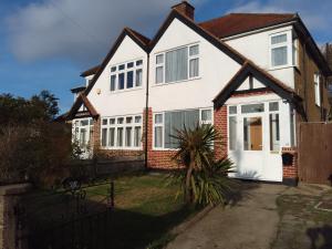 a white house with a white door at Twin home with free parkings, Surbiton, Kingston upon Thames, Surrey, Greater London, UK! in Surbiton