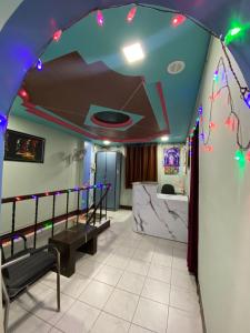 a room with a ceiling decorated with christmas lights at MUKTAI LODGE in Solapur
