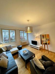 a living room with a couch and a table at Appartement Hyper Centre Place Kléber in Strasbourg