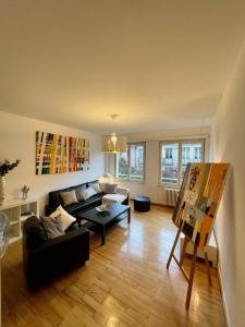 a living room with a couch and a table at Appartement Hyper Centre Place Kléber in Strasbourg