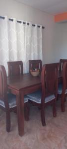 a wooden table and chairs with a bowl on top at Apartamento JM. in San Felipe de Puerto Plata