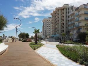 a walkway in a city with tall buildings at Terminal Palace & SPA in Rimini