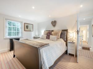 a bedroom with a large bed and a window at Victoria Cottage in Christchurch