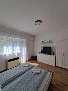 a bedroom with a large bed with two pillows on it at Szofi Apartman in Szeged