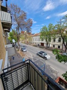 a view of a street with cars parked on the road at Szofi Apartman in Szeged