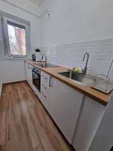 a kitchen with a sink and a counter top at Szofi Apartman in Szeged