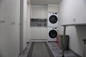 a kitchen with a washing machine and a washer and dryer at Your home away from home! in Rovaniemi