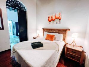 a bedroom with a bed with an orange bag on it at Tanca 255 Spacious Colonial House @ Old San Juan in San Juan