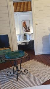 a room with a table in front of a door at Villa de Bois Blanc Strelitzia in Saint-Leu