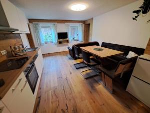 a kitchen and living room with a table and chairs at Selauerbauer in Lofer