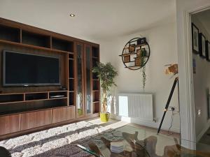 a living room with a television and a table at Holly Crescent, Sacriston DH7 in Sacriston