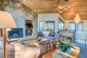 a living room with a couch and a fireplace at White Elm - Unit 31 in Sunriver