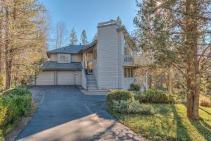 a house with a garage and a driveway at White Elm - Unit 31 in Sunriver