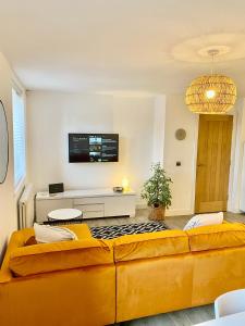 a living room with a couch and a tv at Boutique Chapel Apartment within City Walls in Chester