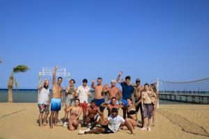 a group of people posing for a picture on the beach at Amwaj Beach Club Abu Soma in Hurghada