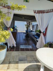 a living room with a couch and a table at Pousada Sol da Manhã in Guarujá