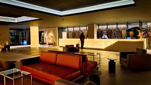 a lobby with a couch and a bar in a building at Alambique - Hotel Resort & Spa in Fundão