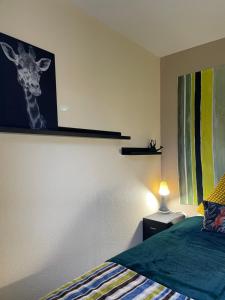 - une chambre avec une photo de girafe sur le mur dans l'établissement *A setting between Dordogne and swimming pool*, à Argentat