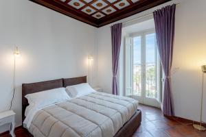 a bedroom with a bed and a large window at The Attico: best view of Rome in Rome