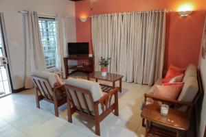 a living room with a couch and a table at Trilogy Villas in English Harbour Town