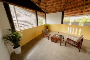 a living room with two benches and a table at SeaCoast Inn FortKochi in Fort Kochi