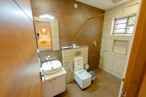 ein Bad mit einem WC und einem Waschbecken in der Unterkunft SeaCoast Inn FortKochi in Fort Kochi