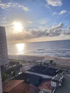 a view of the beach from a balcony of a building at Apto. a 40m da praia - Itanhaém. in Itanhaém