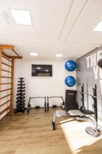 a gym with several cardio machines in a room at Apto. a 40m da praia - Itanhaém. in Itanhaém